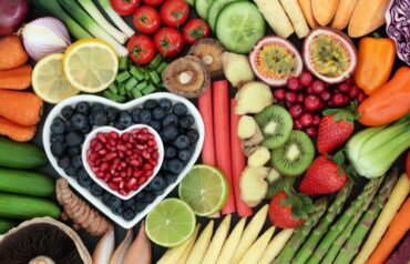 A variety of high-fiber foods and superfoods like berries, nuts, and greens arranged on a wooden table to represent healthy eating trends for a better lifestyle.
